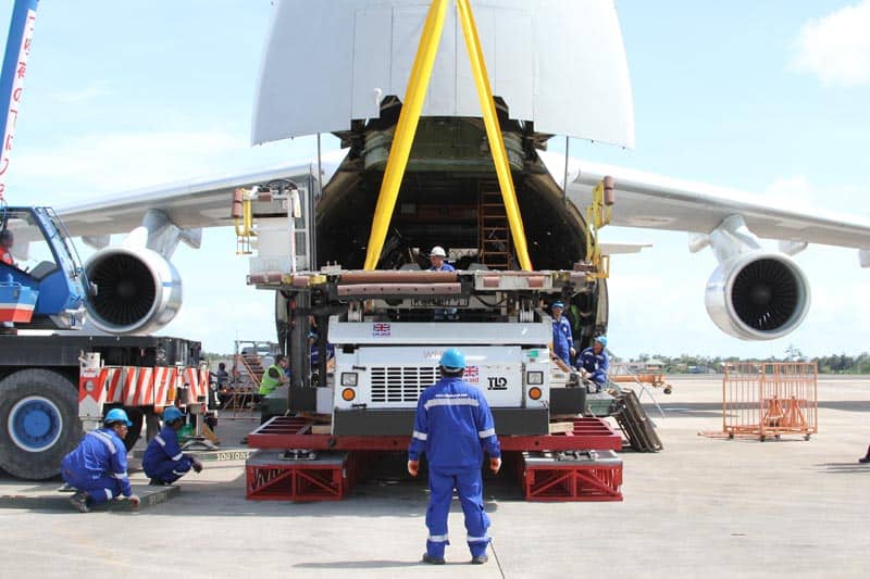 image of men loading items into the back of an airplane