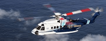 image of a helicopter flying over a stretch of water