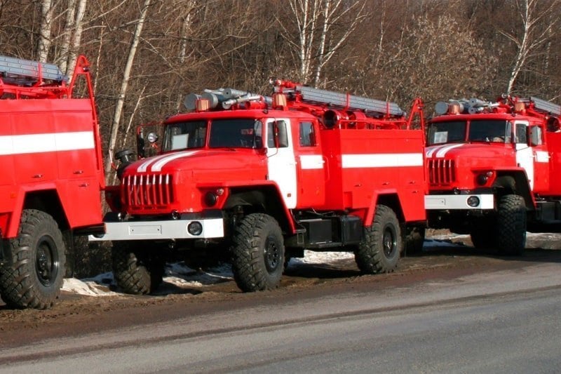 image of three large red trucks used for emergency situations