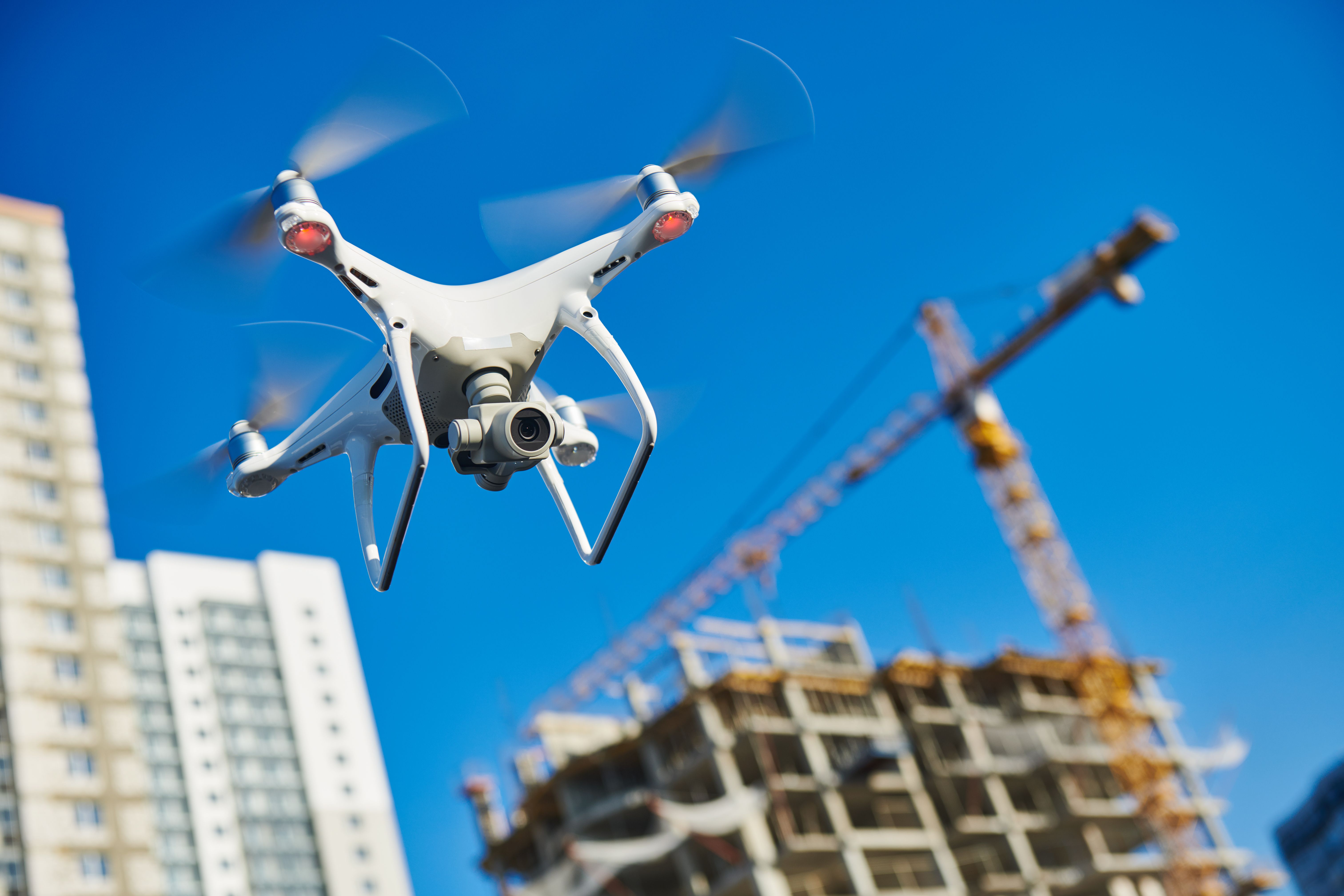 Autonous drone flying near a building being constructed