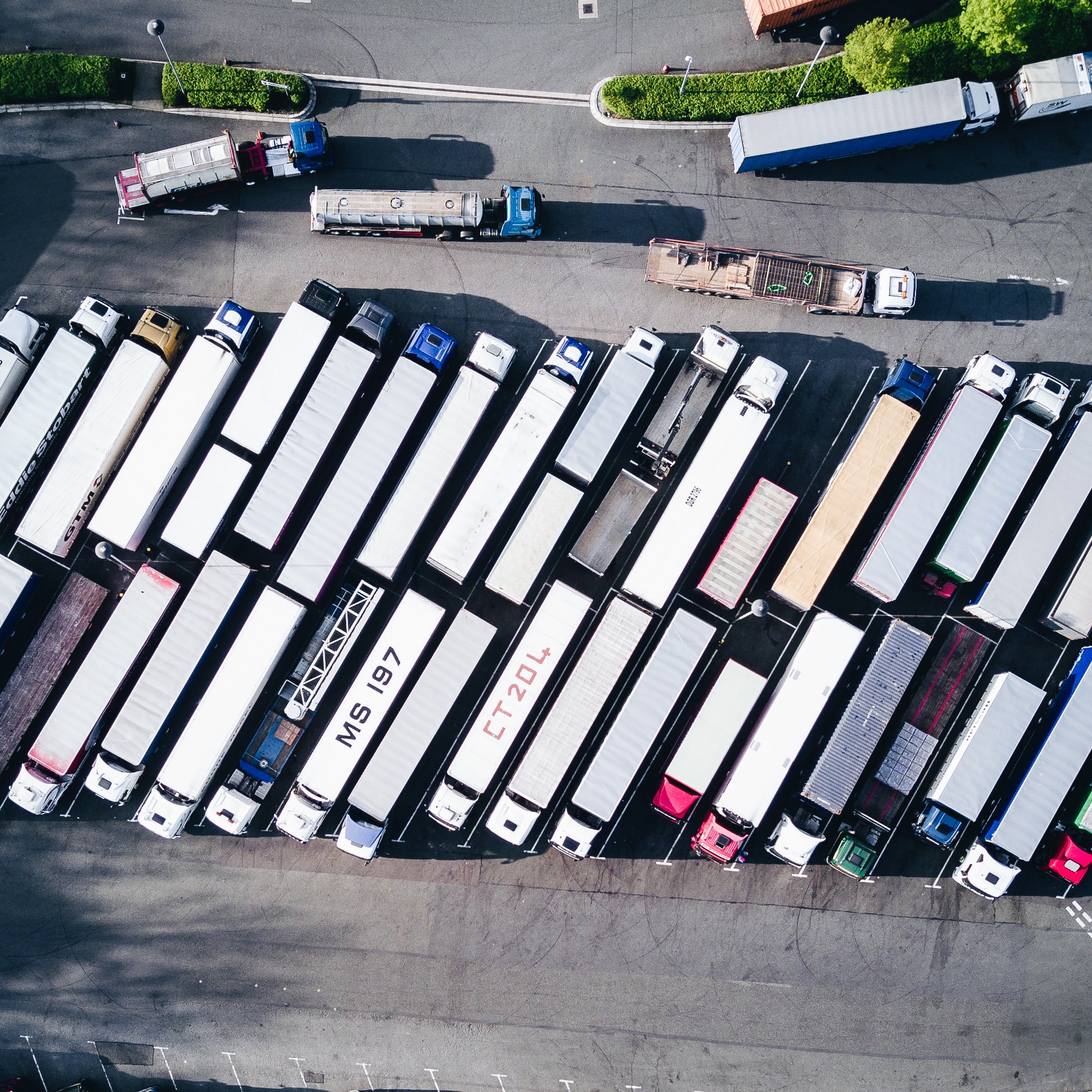 A parking lot of 18-wheeler trucks